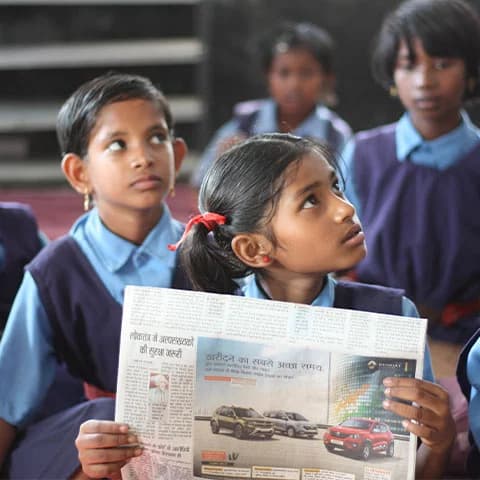 Children in school uniforms reading together